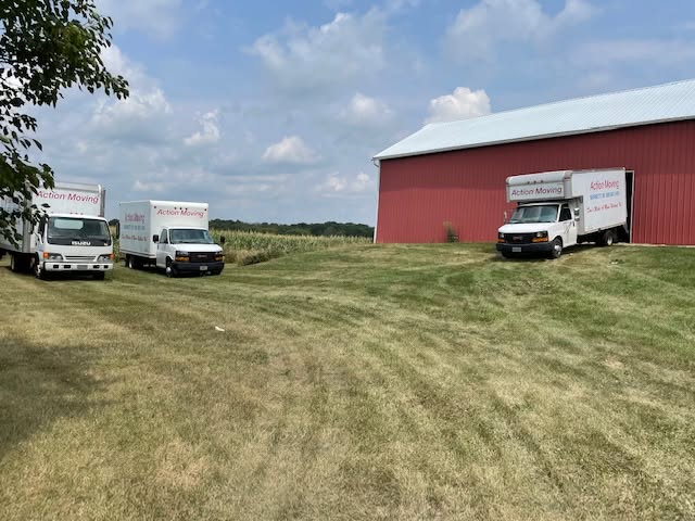 Action Moving trucks parked near a red building
