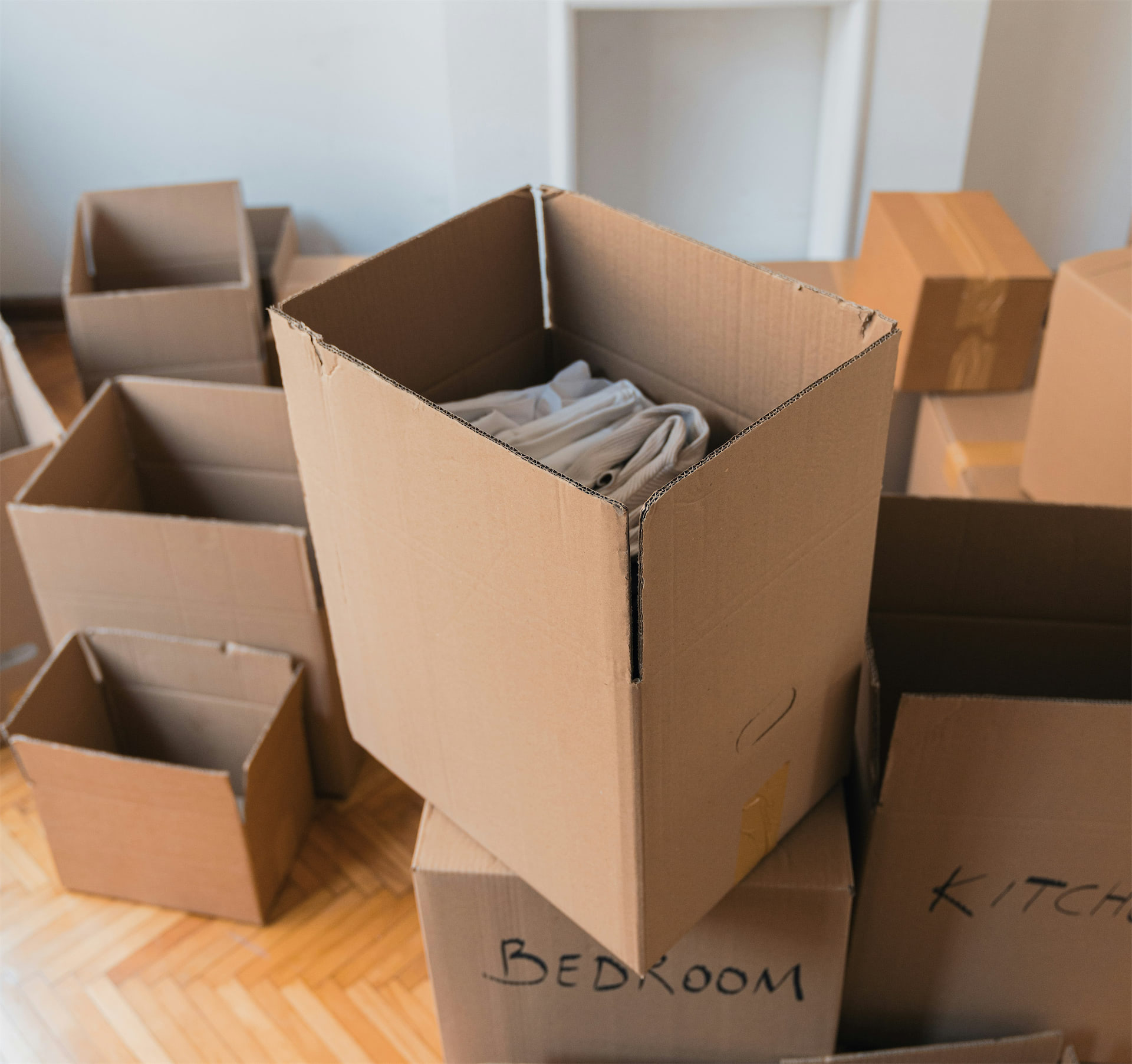 Cardboard moving boxes arranged in a room